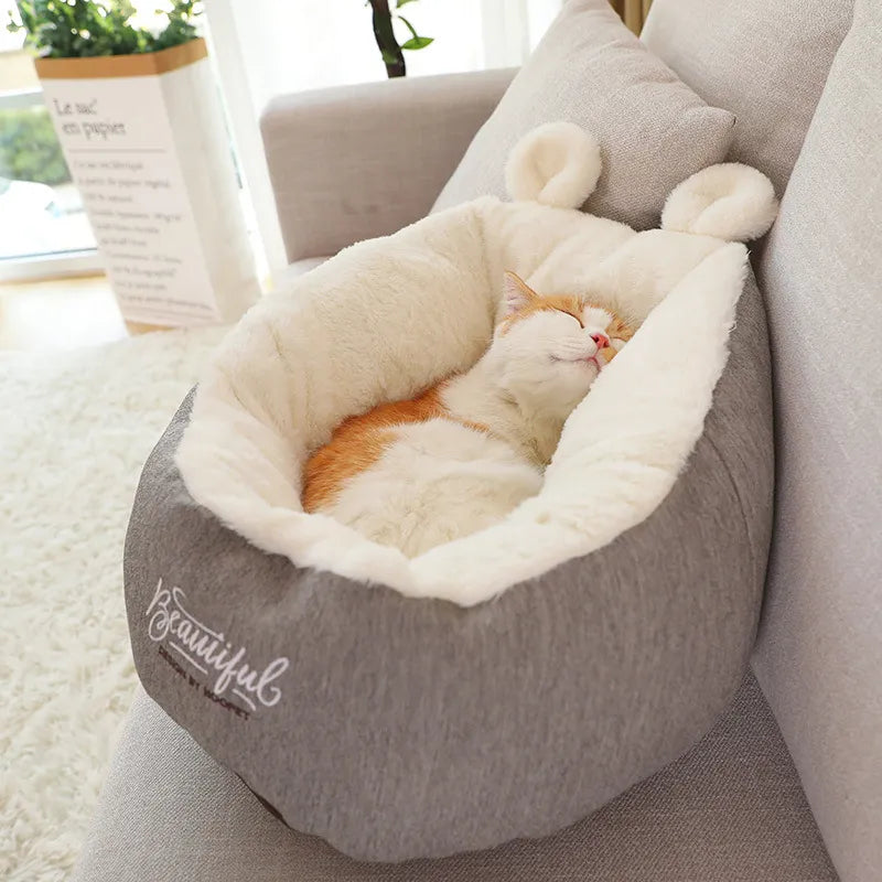 Cozy gray pet bed with cute ear design for cats and small dogs, promoting animal comfort.