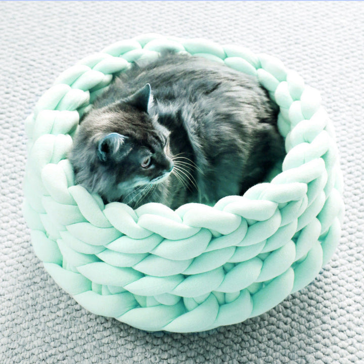 Luxurious knitted cat bed, a cozy pet accessory designed for deep sleep and feline relaxation.