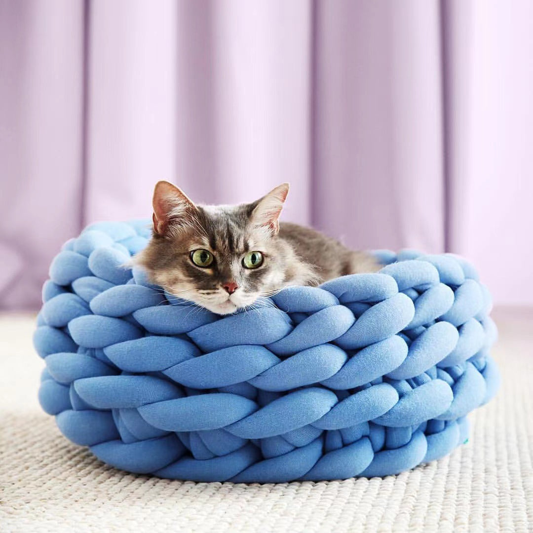 Close-up of a cozy knitted cat bed, showcasing its soft, chunky knit texture and pet-friendly design.