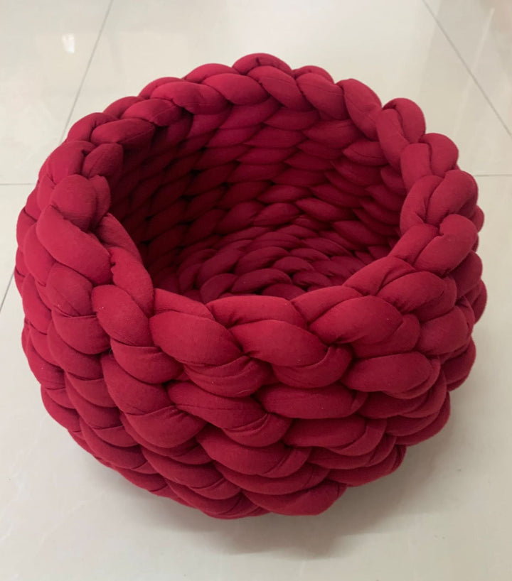 Comfortable knitted cat bed, a snug haven for cats, promoting relaxation and secure sleep.