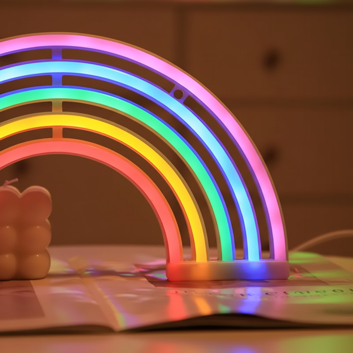 Decorative LumiRainbow neon rainbow table lamp, casting a colorful glow. Great for cozy bedroom & nursery lighting.