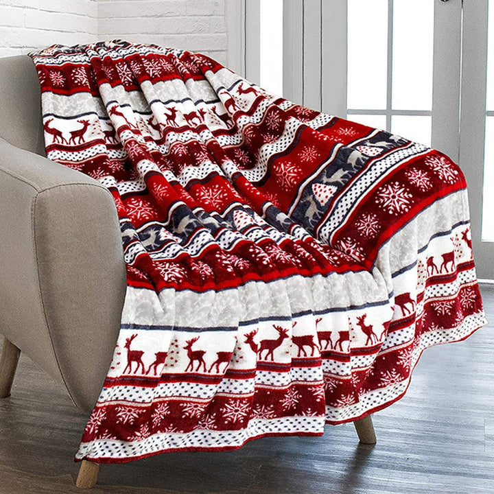 Cozy Nordic plush throw blanket with red reindeer and snowflake pattern, perfect for holidays