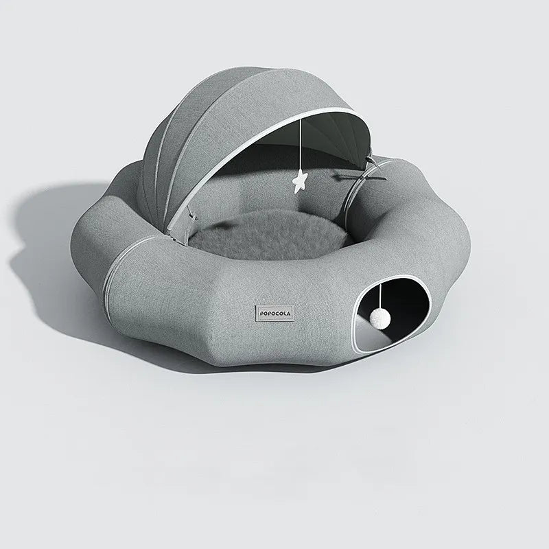 Small pet bed with a protective removable roof and an attached toy for feline and canine fun.