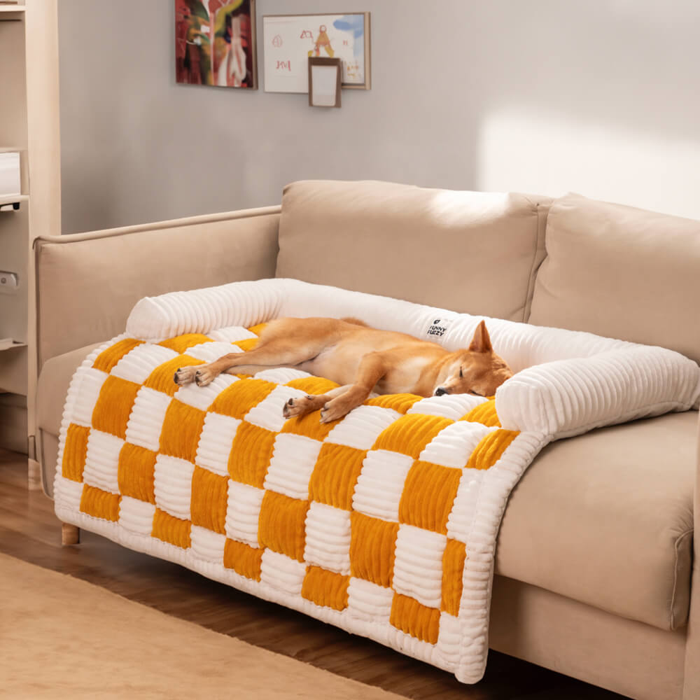 Versatile plaid pet mat, serves as a dog bed, blanket, and furniture protector.