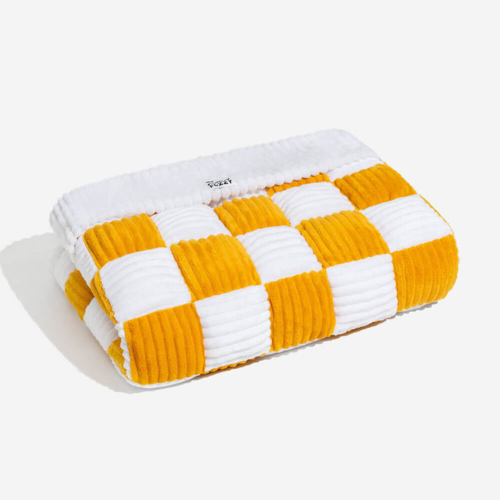 Close-up of the anti-slip base of the plaid pet mat, showing its grip.