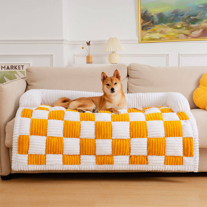 Unisex plaid couch cover for pets, soft and warm, shown on a brown leather armchair.