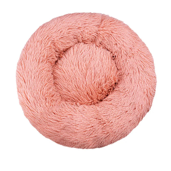 Cozy plush round dog bed, donut-shaped, in a neutral color, perfect for small to medium pets.