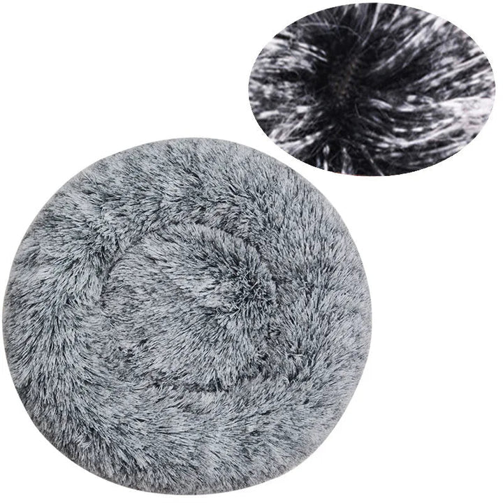 Soft round pet bed, machine washable plush fabric, donut type for all-season comfort.