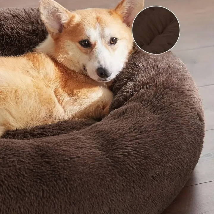 Unisex cat bed, plush and deep for comfort, a washable round donut design for cozy rest.