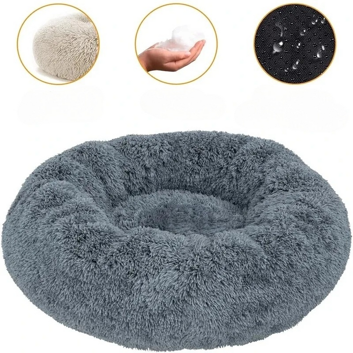 Soft pet bed, round donut style with supportive edges, ideal for dogs and cats to snuggle.