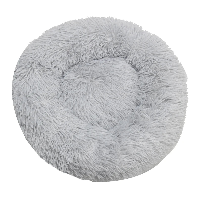 Gray plush round cat bed, a cozy donut shape inviting pets for a luxurious sleep.
