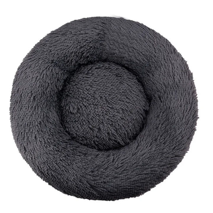 Unisex pet furniture, a cozy plush round bed, donut-shaped for dogs and cats.