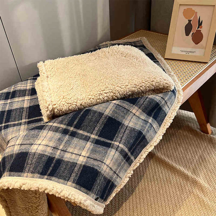 Plush brown plaid sherpa fleece pet blanket, machine washable for easy care.