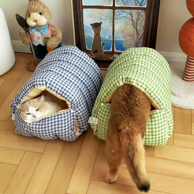 Lifestyle shot of a cat comfortably sleeping in a warm, washable winter pet bed, cozy and soft