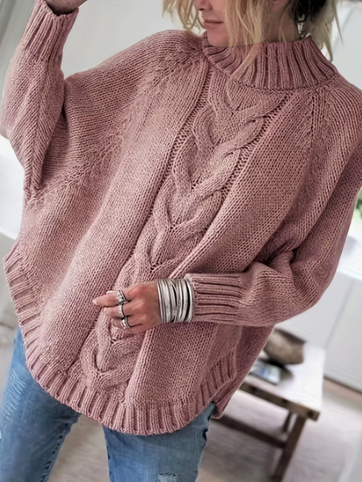 Cozy women's cable knit high-neck sweater, oversized with a stylish flared hem for fall.