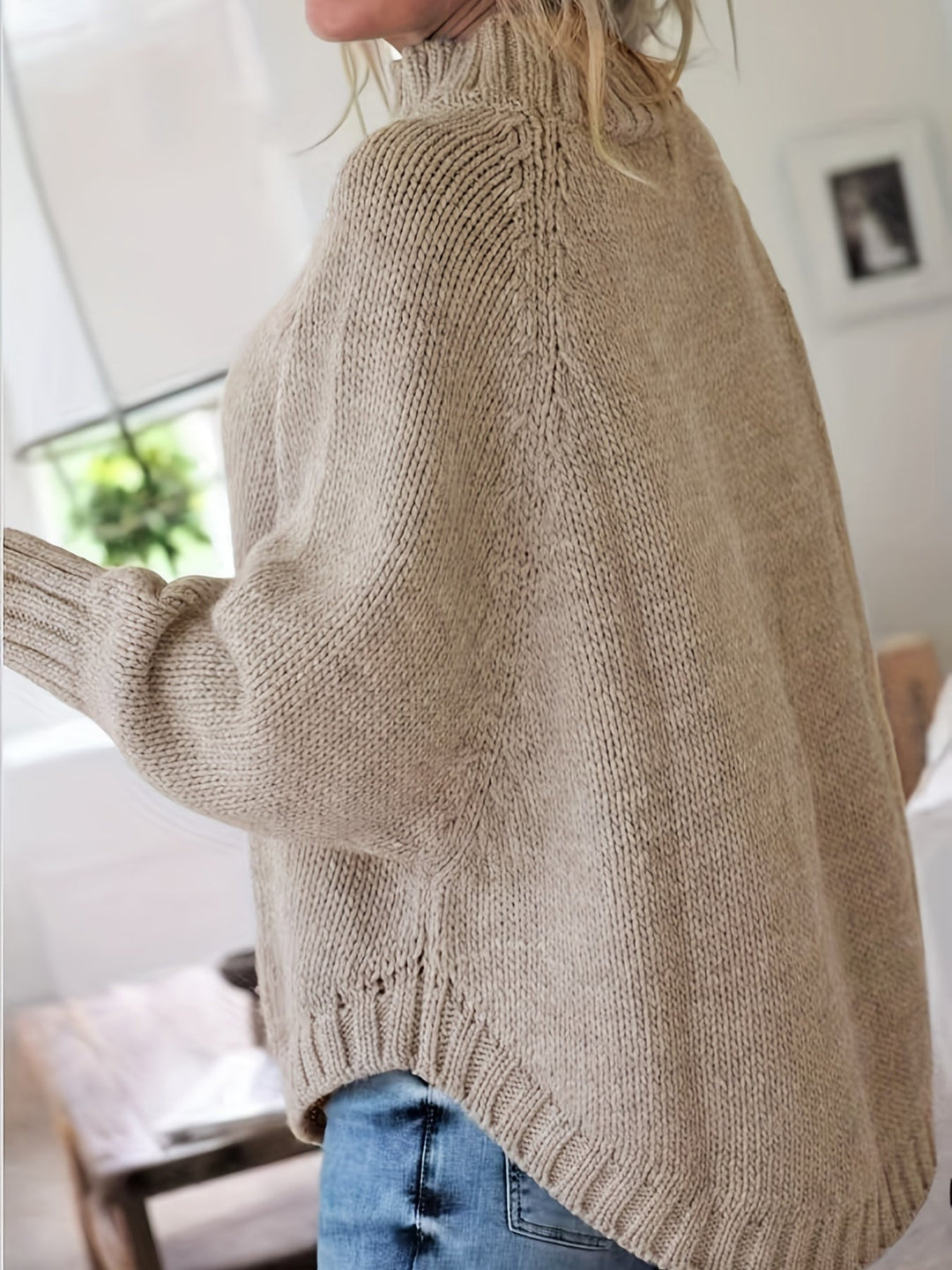 Vintage-inspired women's cable knit sweater, high-neck, with a cozy feel and elegant flared hem.