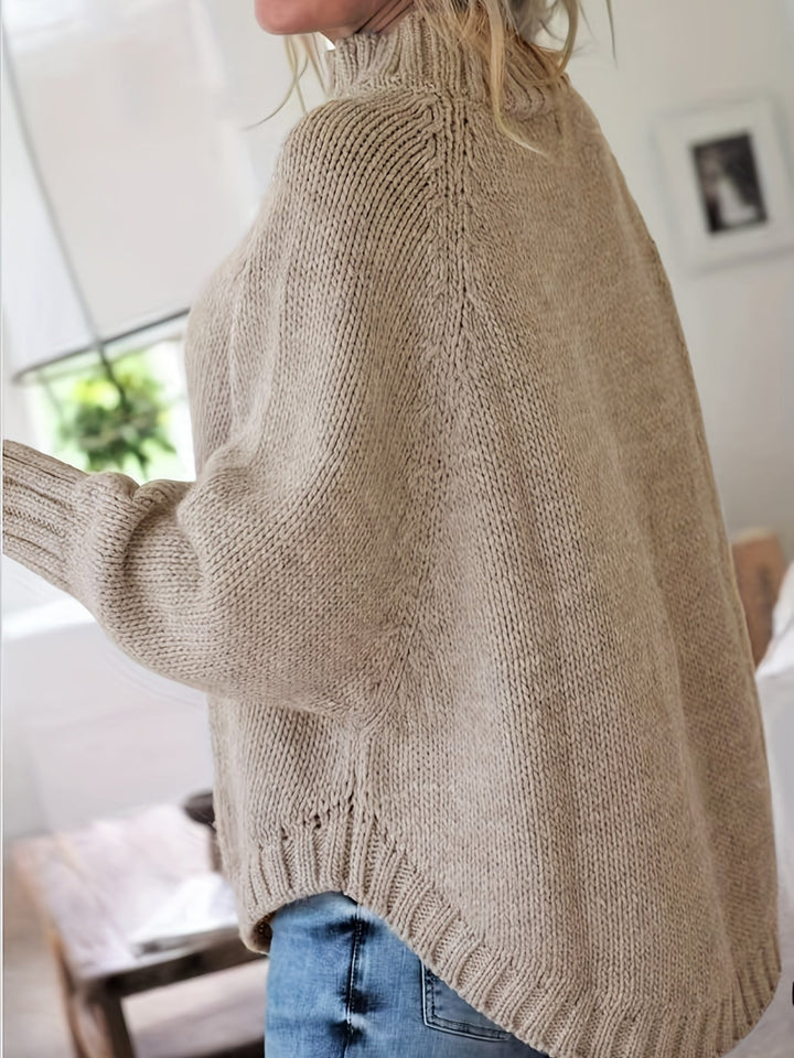 Vintage-inspired women's cable knit sweater, high-neck, with a cozy feel and elegant flared hem.