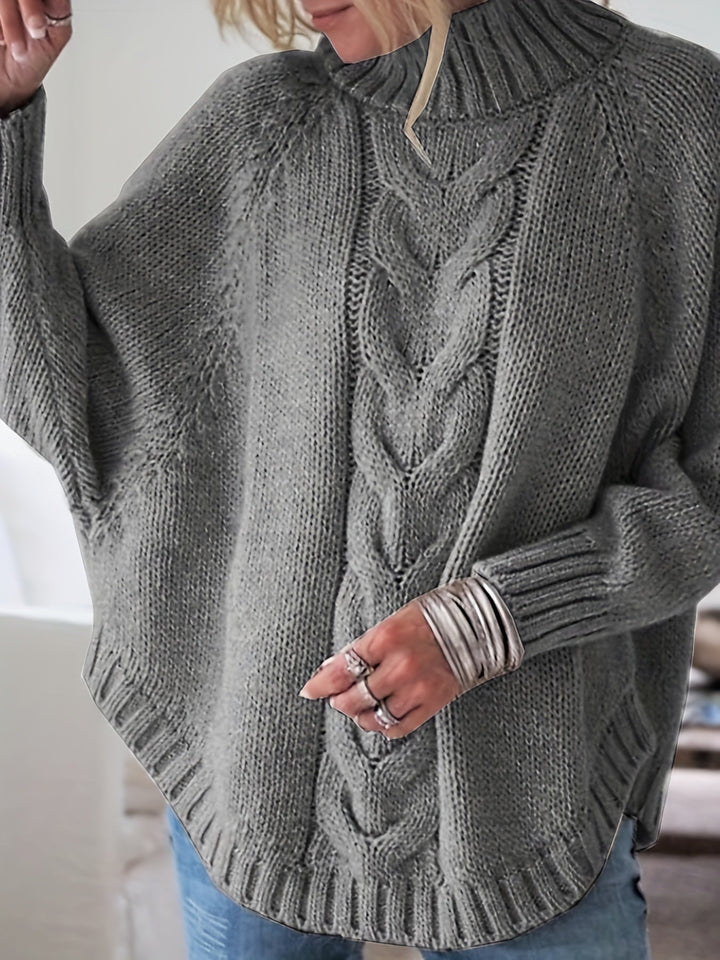 Casual women's high-neck cable knit sweater featuring a vintage-inspired flared hem detail.