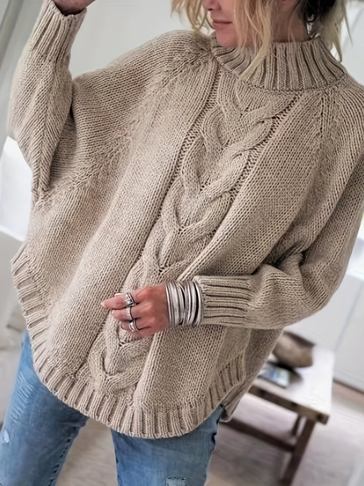 Close-up of the intricate cable knit pattern on a warm women's high-neck sweater.