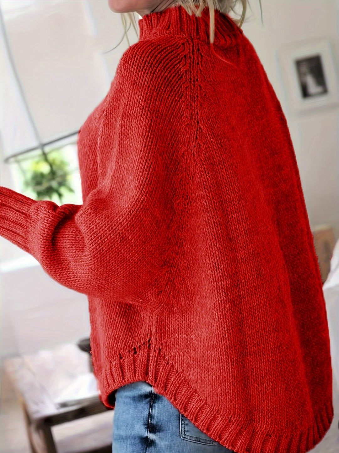 Stylish women's winter wear: a cozy cable knit sweater with a high neck and batwing sleeves.