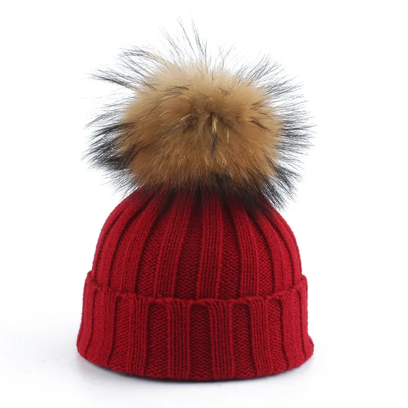 Women's comfy winter beanie hat, designed with a stylish faux fur pom-pom to keep you warm in cold weather.