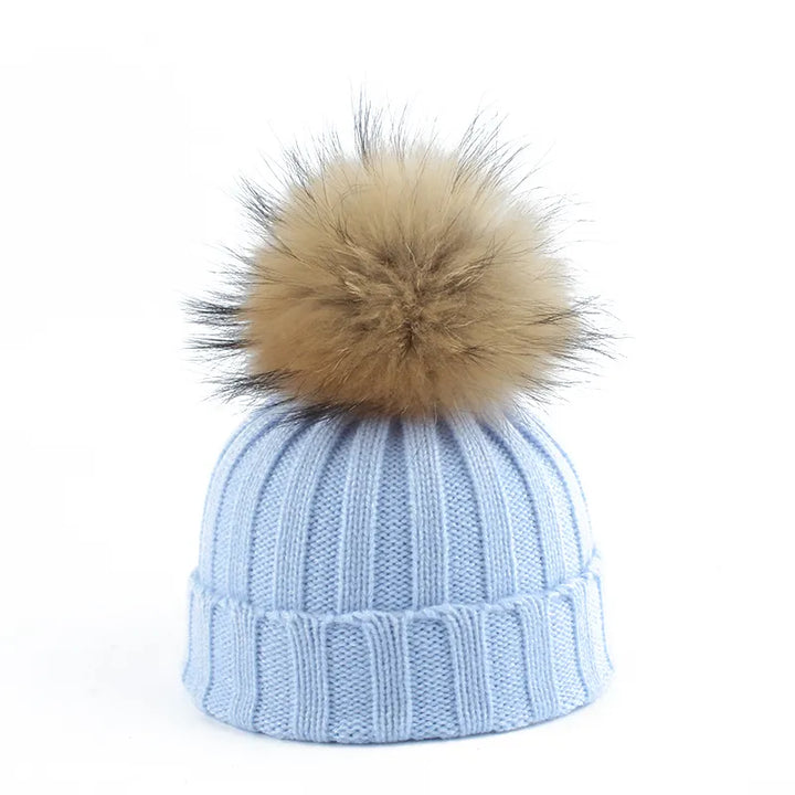 Cozy women's winter beanie with a luxurious faux fur pom-pom. Essential cold weather headwear for women.