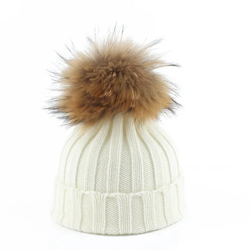 Fashionable women's winter hat: a cozy beanie with an adorable faux fur pom-pom. Perfect stylish cold weather accessory.