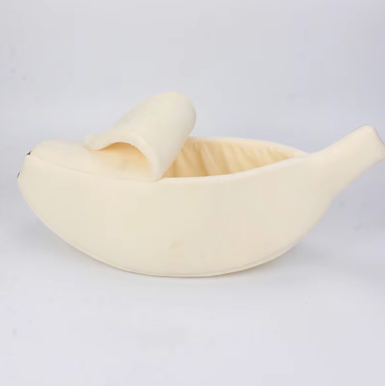 Yellow banana pet bed with a soft interior, suitable for both cats and dogs.