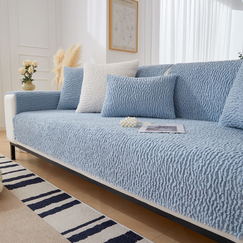 Measuring a sofa for a cream berber fleece couch cover, emphasizing universal fit