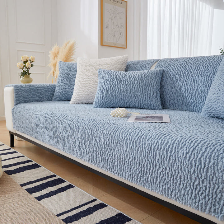 Measuring a sofa for a cream berber fleece couch cover, emphasizing universal fit