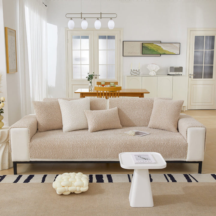 Sectional couch covered with a cream berber fleece protector, anti-scratch & washable