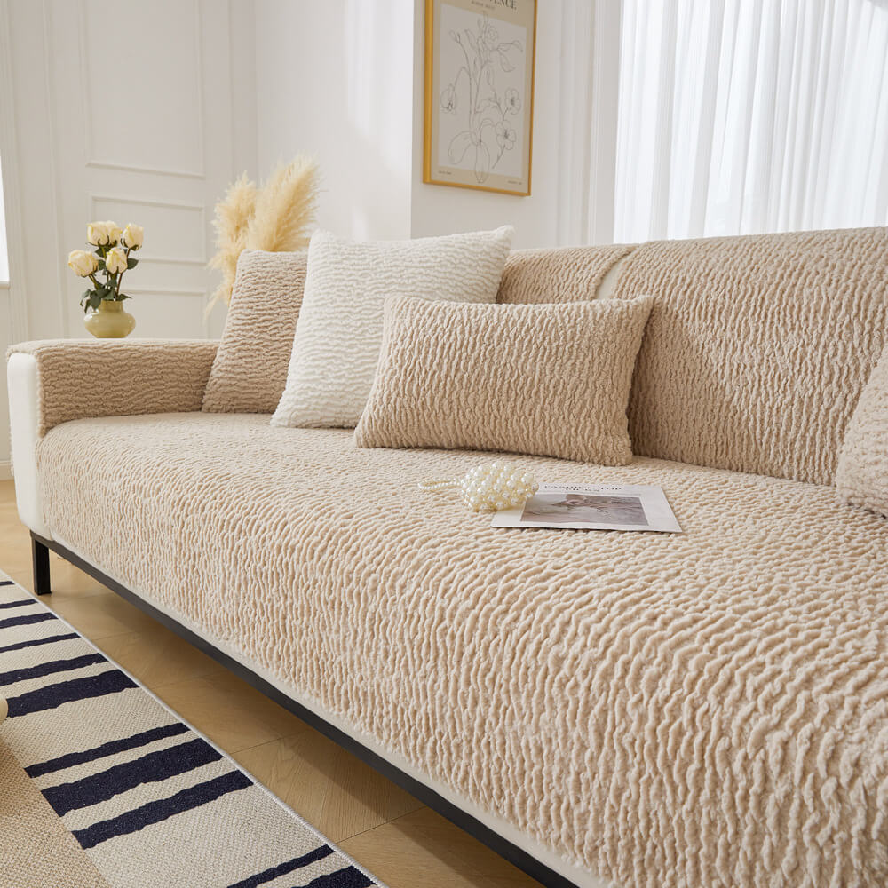 Cream sofa protector on a couch, showing its anti-scratch and pet friendly features