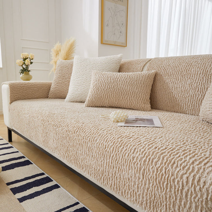 Cream sofa protector on a couch, showing its anti-scratch and pet friendly features