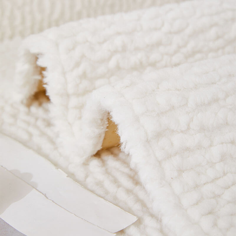 Full view of a living room with a cream berber fleece couch cover, non-slip design