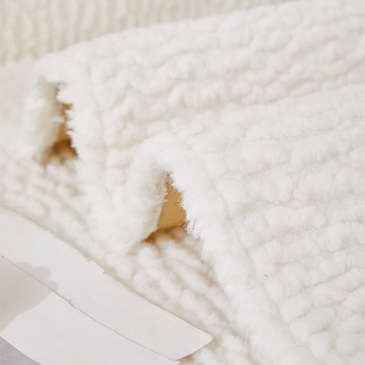 Full view of a living room with a cream berber fleece couch cover, non-slip design