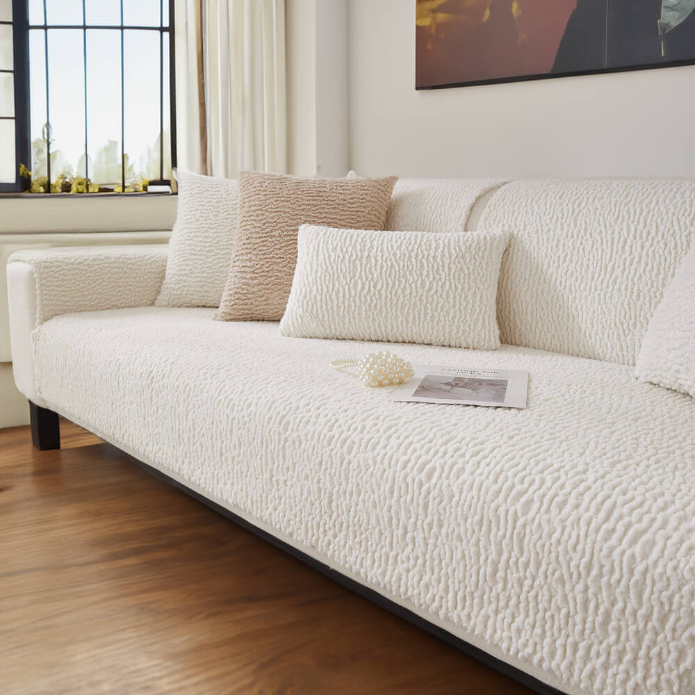 Detail of the soft, cream berber fleece fabric of an anti-scratch sofa cover