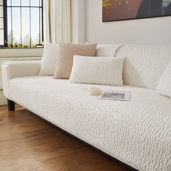 Detail of the soft, cream berber fleece fabric of an anti-scratch sofa cover