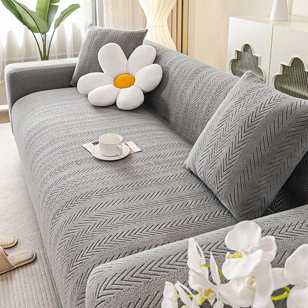 Cream herringbone stretch sofa slipcover, pet-friendly elastic couch cover for living room furniture protection.