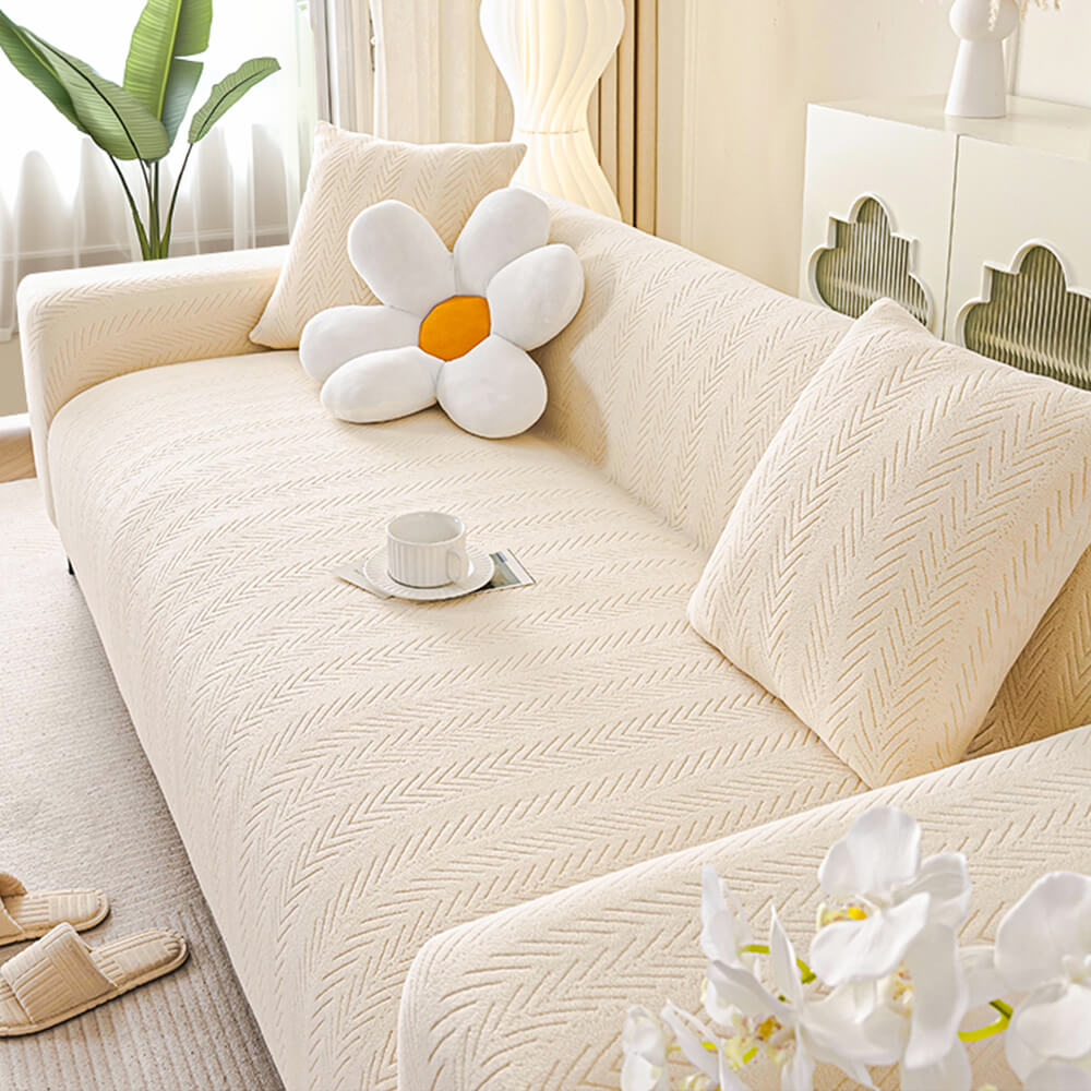 Comfortable cream herringbone couch protector, elastic stretch slipcover, machine washable for convenience.