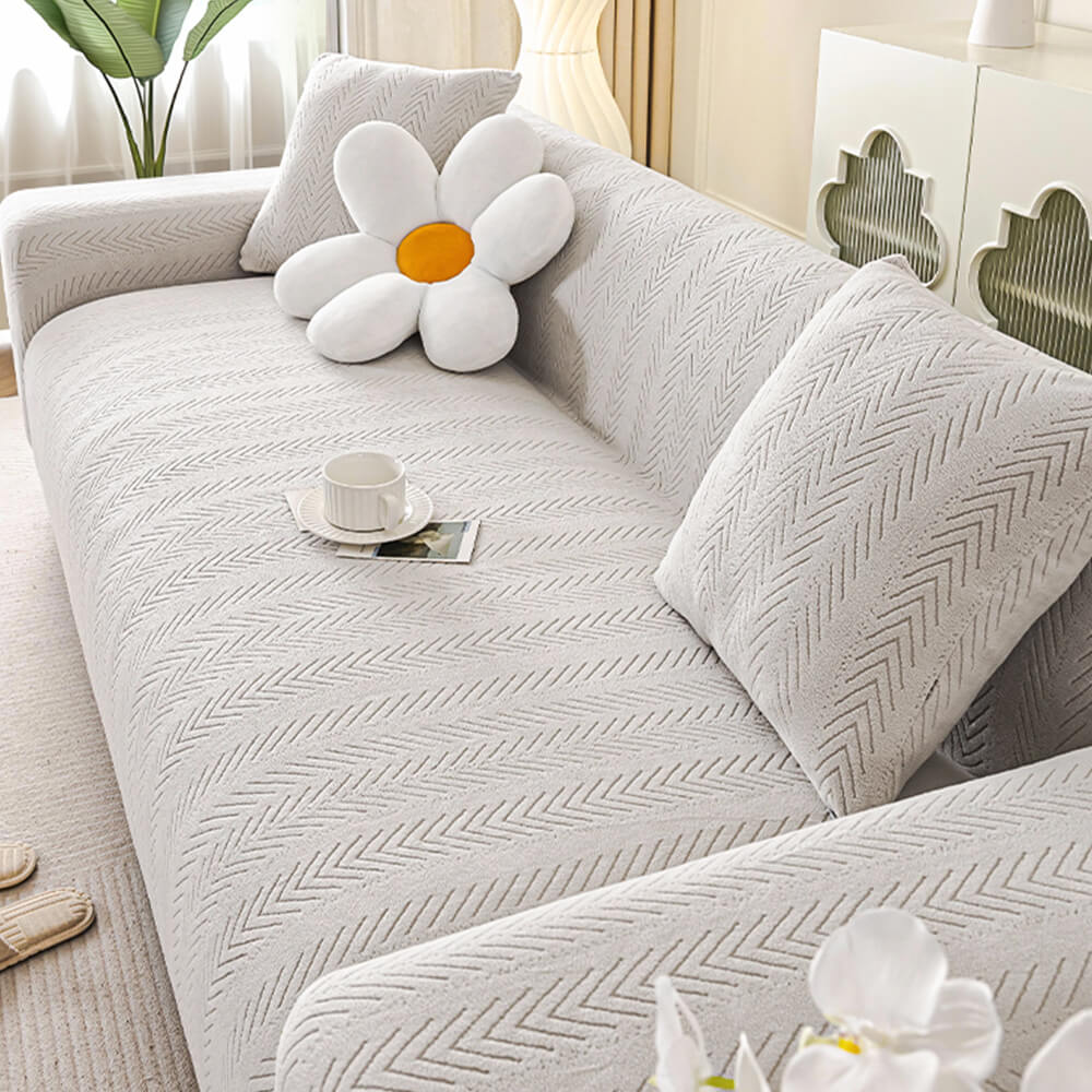 High-quality cream herringbone slipcover, stretch couch cover, machine washable and pet-friendly design.