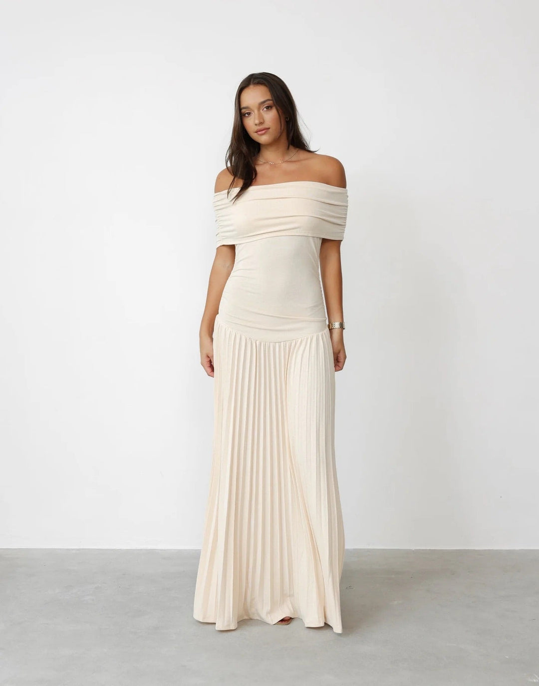 Cream off-shoulder pleated maxi wedding guest dress for women.