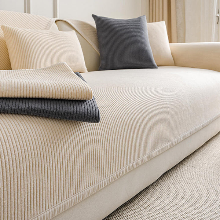 Cream vertical stripes fleece sofa cover, pet-friendly & non-slip, protecting furniture from kids & pets.