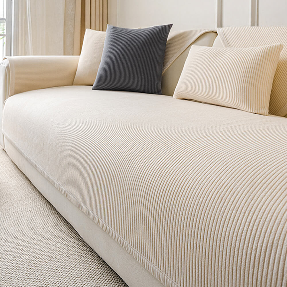 Stylish cream fleece sofa cover with vertical stripes, blending pet-friendly design with modern home decor.