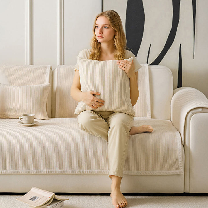 Cream striped fleece sofa cover draped over a couch, highlighting its full coverage & furniture protection.