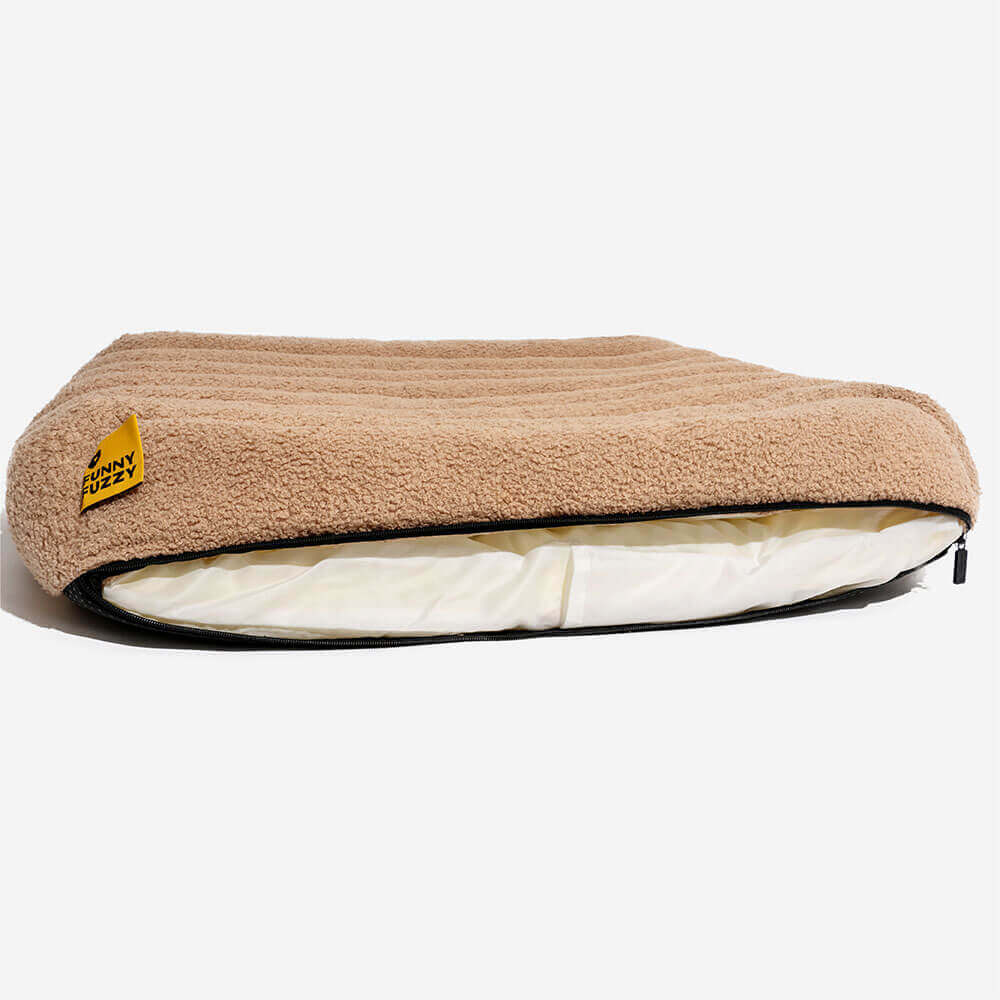 Cozy pet bed, creamy, washable, orthopedic for peaceful sleep.