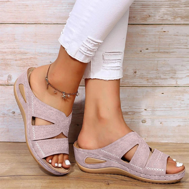 Orthopedic women's sandals, adjustable cross-straps ensure custom fit & arch support for all-day comfort.