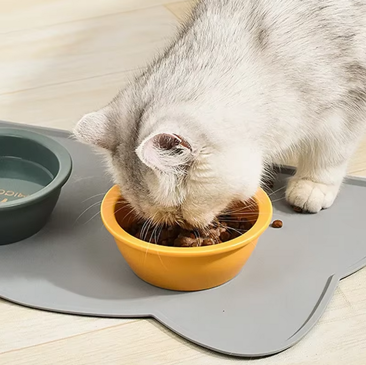 Non-slip pet feeding mat in a charming cat shape, made from silicone to keep cat bowls secure.