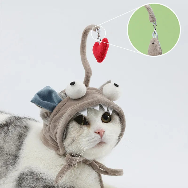 Adorable kitten with a cat costume hat featuring a dangling feather, perfect for playtime.