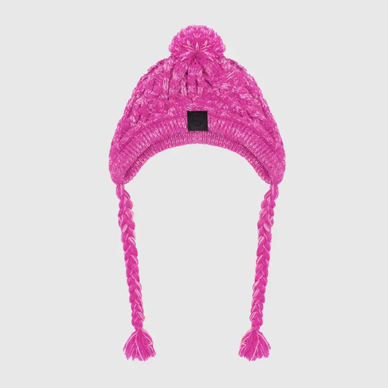 Side view of a cat in a white knitted pet hat with pigtails and a pompom, cute and cozy winter pet gear.