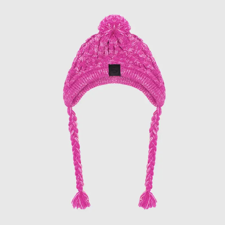 Side view of a cat in a white knitted pet hat with pigtails and a pompom, cute and cozy winter pet gear.
